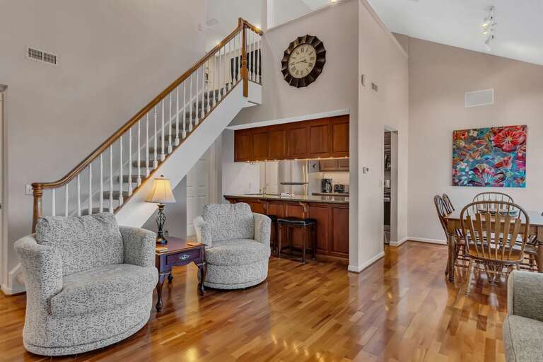 Interior Living Space With Staircase And Kitchen