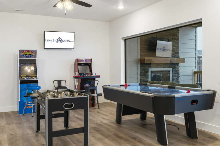 Game Room With Pool Table, Foosball, And Arcade Machines