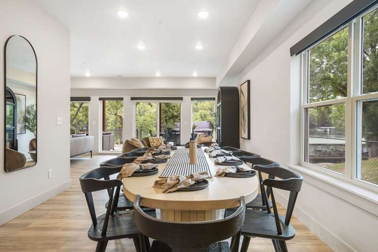 Interior Dining Area With Large Table And Chairs Near Window