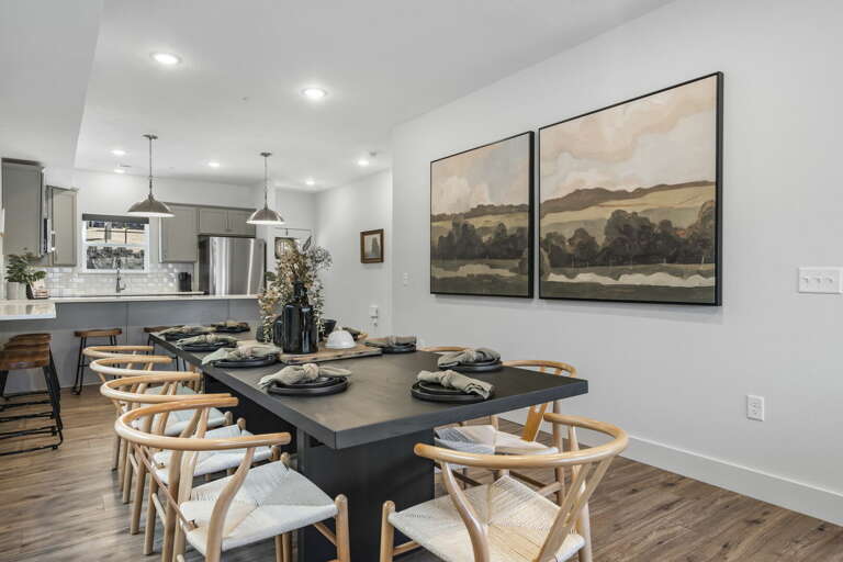 Interior Dining Area With Table Set For Six And Kitchen In Background Interior Dining Area With Table Set For Six And Kitchen In Background