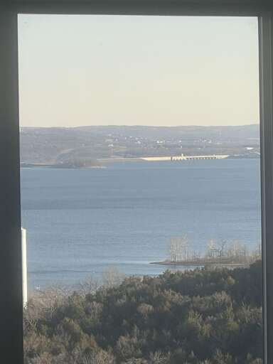 View Of Vivid Blue Sea Seen Through Vertical Window Frame