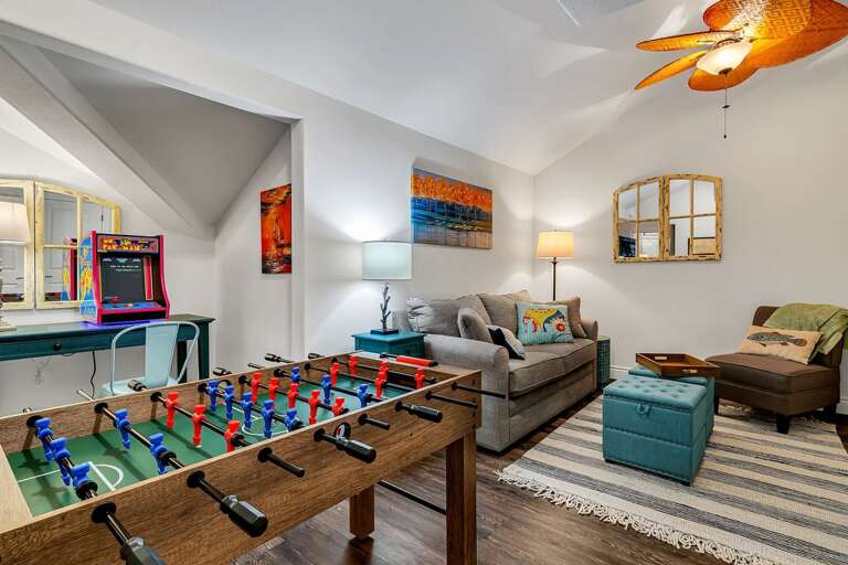 Living Room With Foosball Table, Couch, And Arcade Machine
