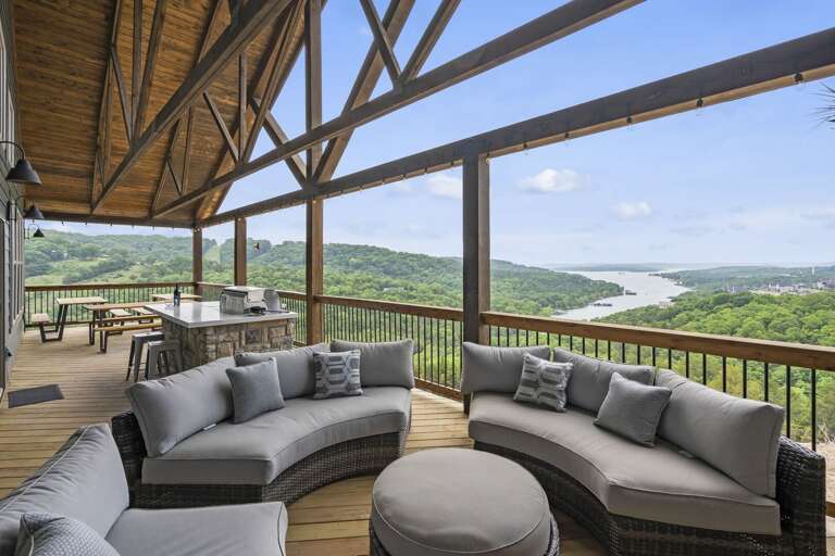 Covered Deck With Furniture Overlooking A River