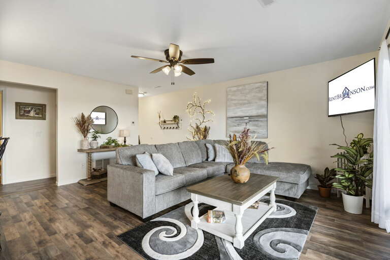 Interior Living Space With Sofa, Coffee Table, And TV