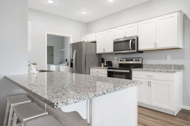 Interior Of A Kitchen With White Cabinets And Stainless Steel Appliances
