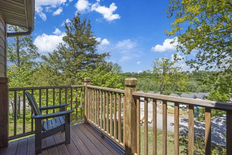 Wooden Balcony With Chairs Overlooking Trees