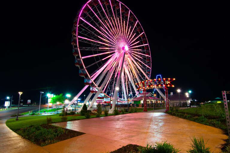 Night-lit Ferris Wheel Near A Winding Walkway