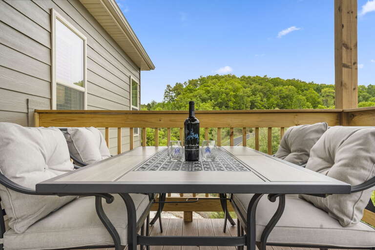 Outdoor Patio With Table, Chairs, And Wine Bottle With Nature View
