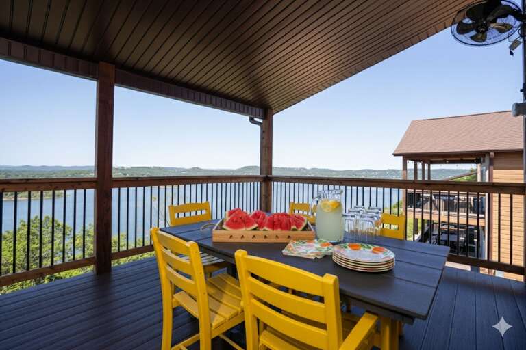 Vacation Rental Veranda Viewing Vast Valley, Vibrant Yellow Chairs Around Outdoor Dining Table