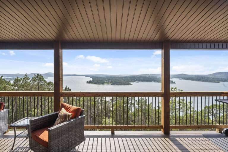 Balcony View Of A Lake With Seating Area