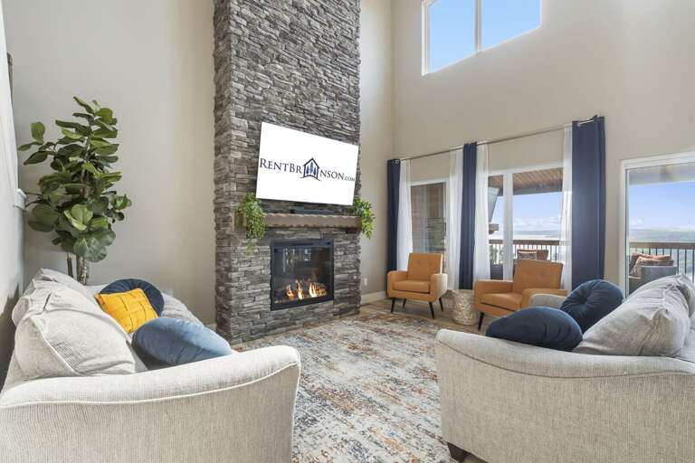 Living Room With Sofas, Fireplace, And Large Windows Living Room With Sofas, Fireplace, And Large Windows