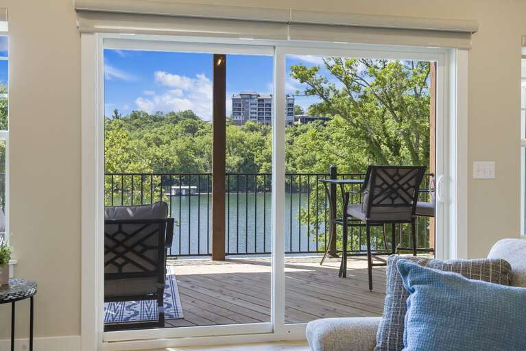 View From Inside A Vacation Rental Onto A Balcony With A Lake View
