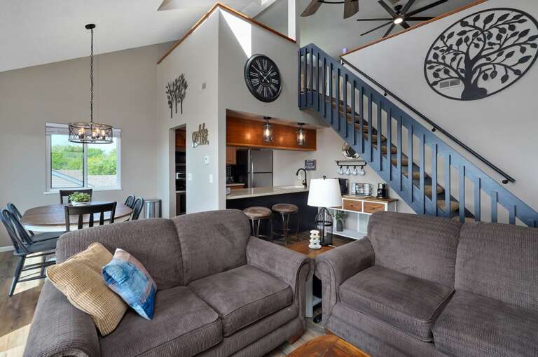Interior Living Space With Staircase And Kitchen Area