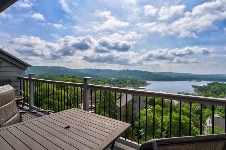 Balcony View Of A Lake And Hills Under A Cloudy Sky Balcony View Of A Lake And Hills Under A Cloudy Sky