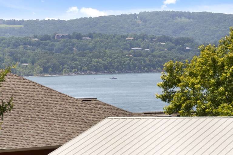 Lake View With Rooftops And Distant Hills