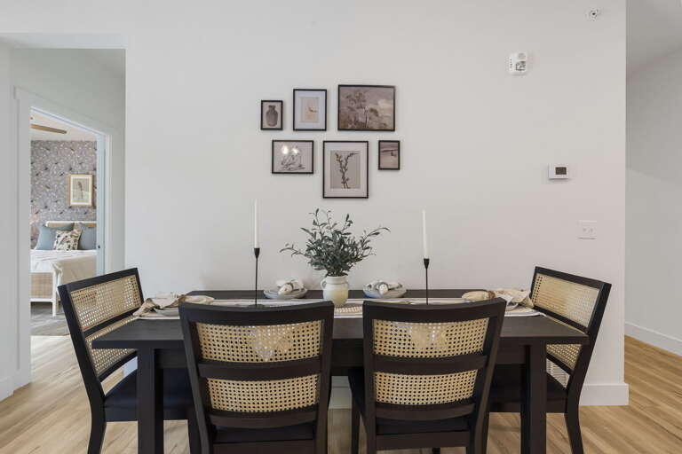 Dining Room With Table, Chairs, And Wall Decorations