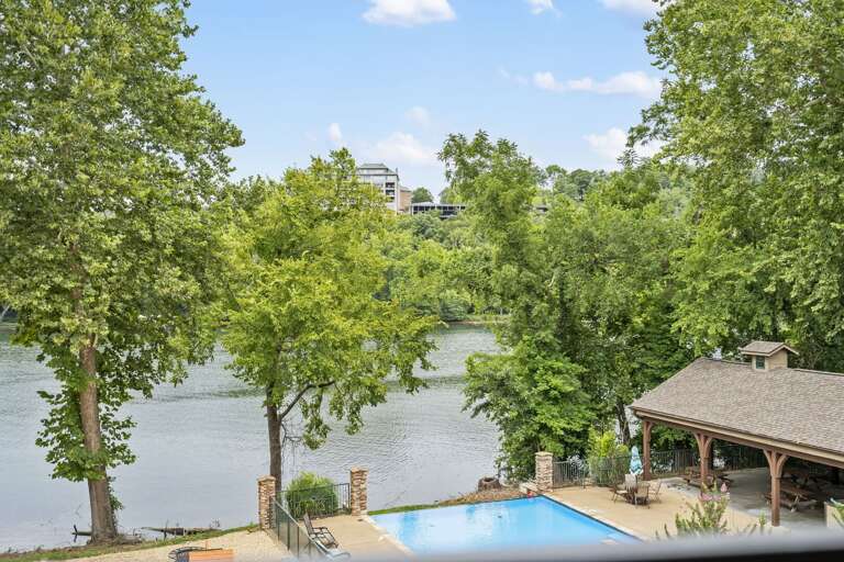 View Of A Pool By A Lake Surrounded By Trees