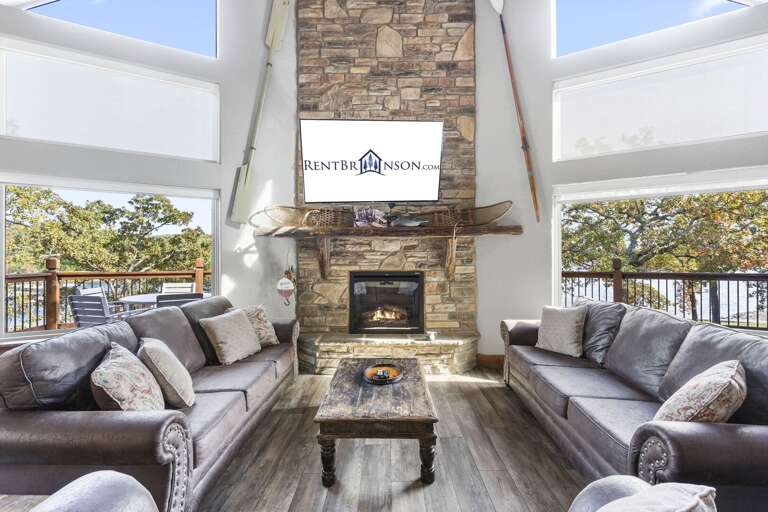 Interior Living Space With Sofas, Fireplace, And Windows