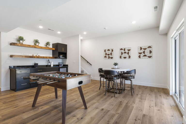 Interior With Kitchenette, Dining Area, And Foosball Table