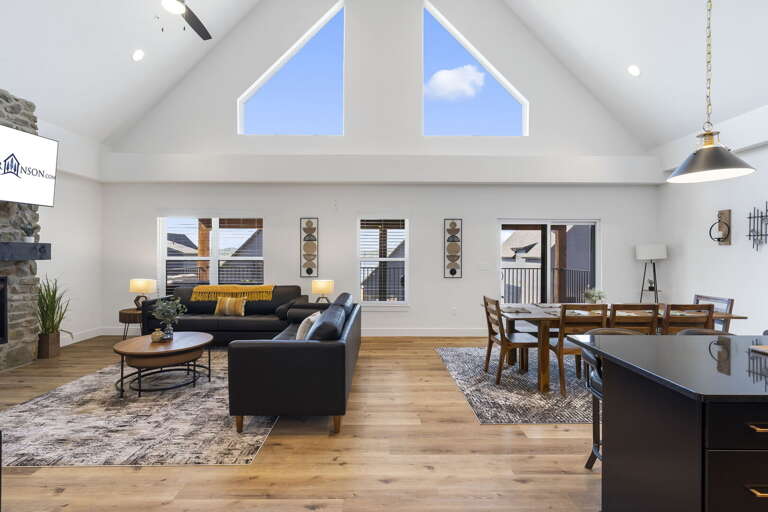 Spacious Interior With Living And Dining Areas, High Ceiling, And Skylights