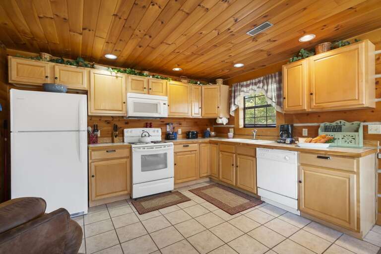 Rustic Kitchen Interior With Wooden Ceiling And Appliances Rustic Kitchen Interior With Wooden Ceiling And Appliances