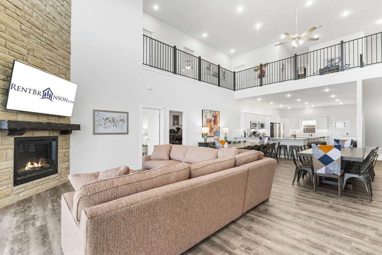 Interior Of A Spacious Living Room With Fireplace And Upstairs Balcony