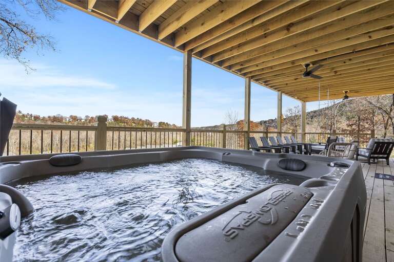 Outdoor Covered Patio With Hot Tub And Chairs Overlooking Scenic View