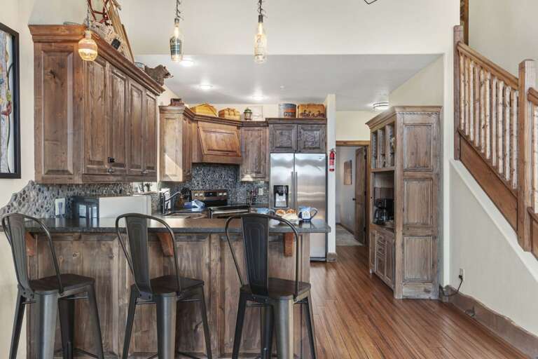 Residential Kitchen With Wooden Cabinets And Bar Stools