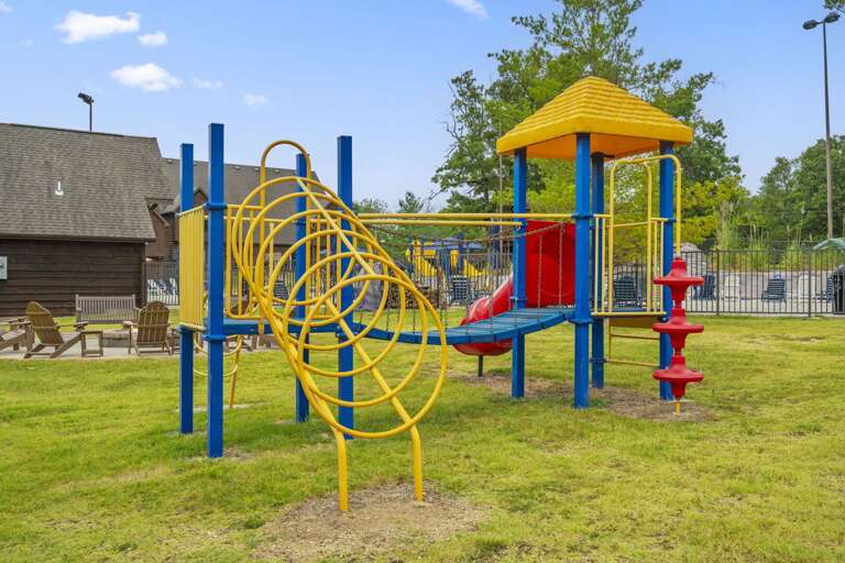 Bright Blue And Yellow Playground With Slides And Climbing Structures