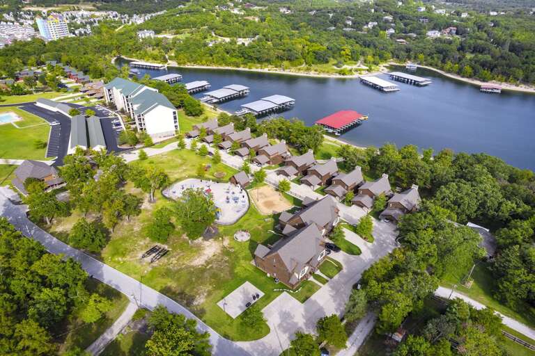 Aerial View Of Lakeside Residential Area With Buildings And Docks Aerial View Of Lakeside Residential Area With Buildings And Docks