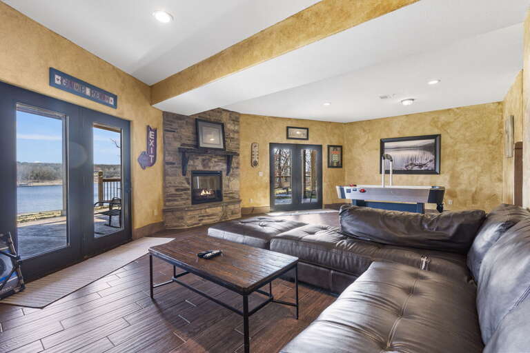 Lake View Living Room With Large Sofa And Fireplace