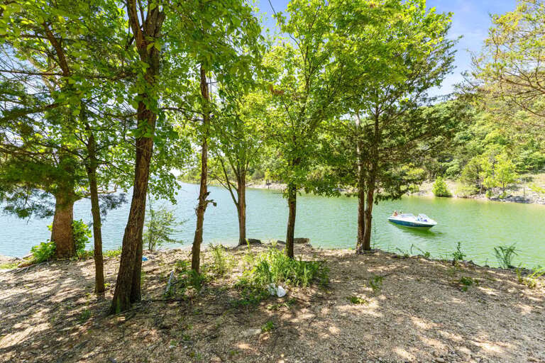 Tranquil Lake View With Trees And Boat