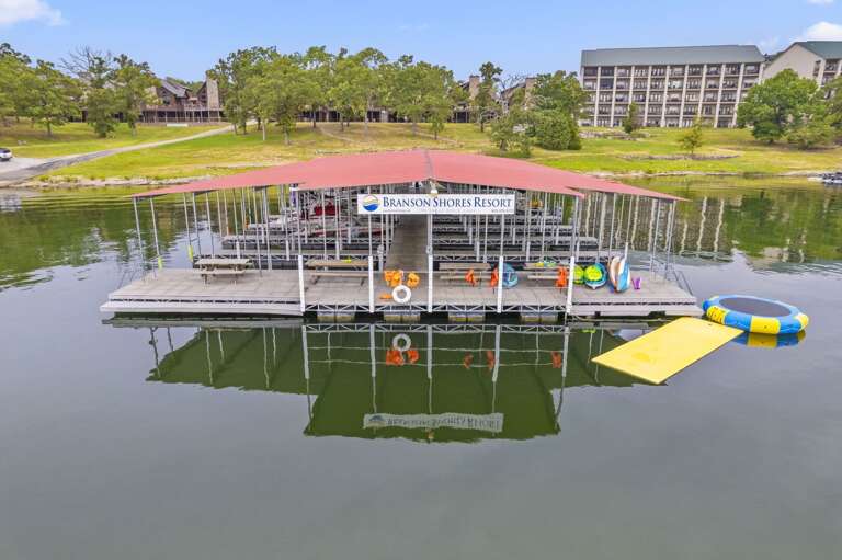 Floating Structure On Serene Lake, Lush Landscape In Background Floating Structure On Serene Lake, Lush Landscape In Background