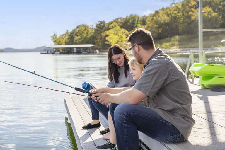 Family Fishing From Dock, Serene Lake Setting Family Fishing From Dock, Serene Lake Setting
