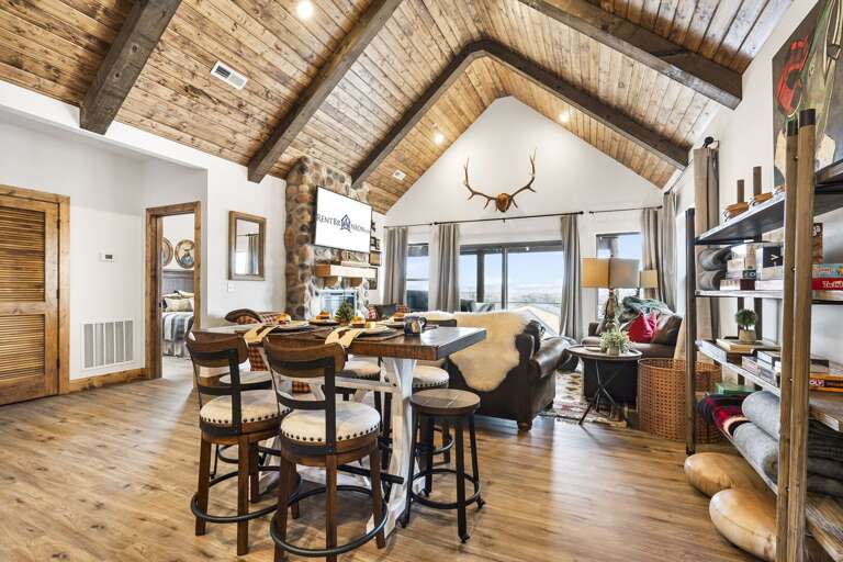 Rustic-style Interior Of A Vacation Rental With Exposed Beams And Antler Decor