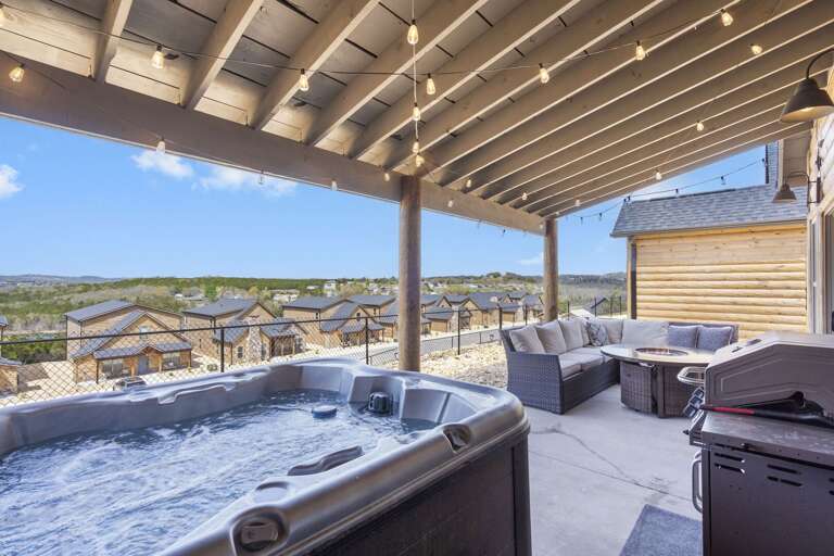 Shaded Patio With Bubbling Hot Tub And Plush Seating Overlooking Scenic Landscape