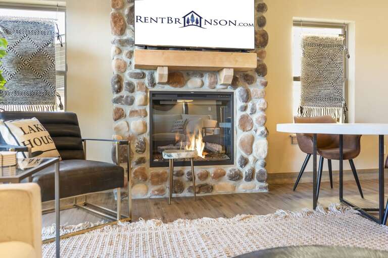 Interior Living Space With Fireplace, Chairs, And A Sign