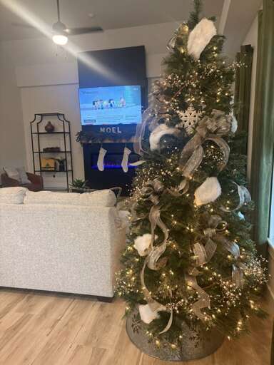 Christmas Tree Twinkling Tantalizingly, Room With Television Displaying Text Christmas Tree Twinkling Tantalizingly, Room With Television Displaying Text