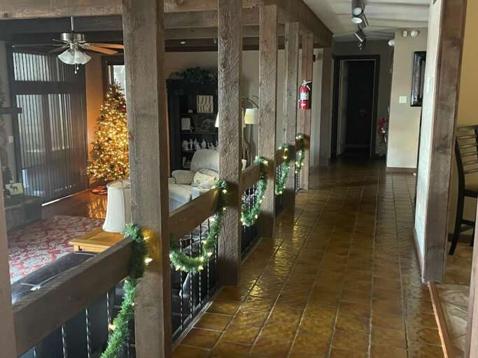 Polished Floors, Festive Lights Lining A Lengthy Lobby