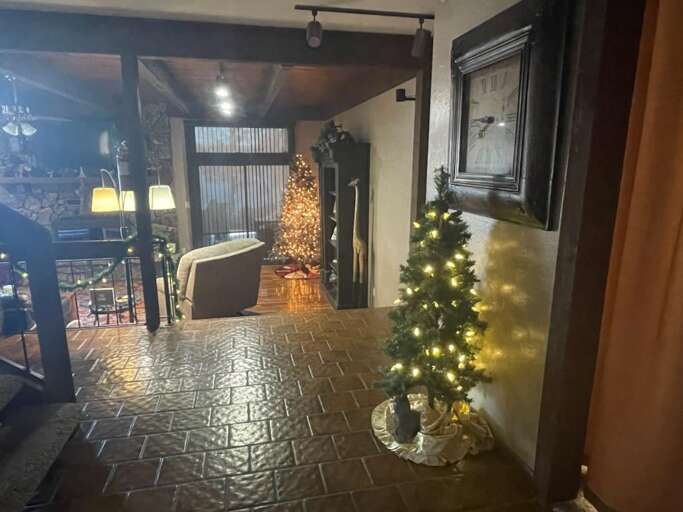 Lobby Lit With Glowing Lights, Adorned With A Festive Tree