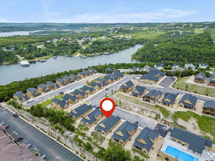 Aerial View Of Residential Area Near River With Red Location Marker