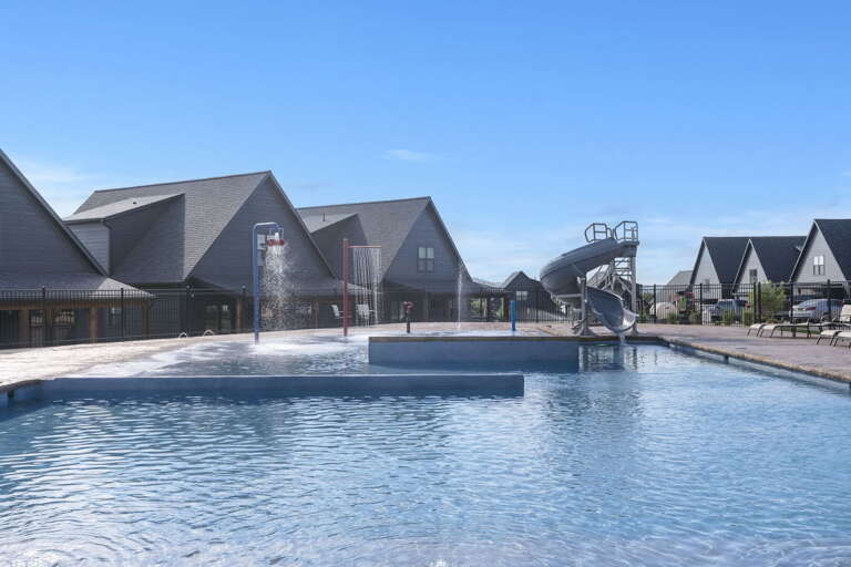 Swimming Pool With Adjacent Houses And Slide