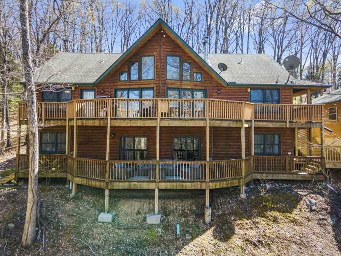 Wooden Vacation Rental Cabin Surrounded By Trees