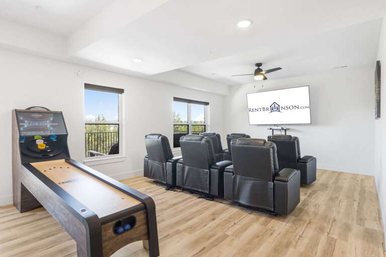 Residential Entertainment Room With Arcade Games, Seating, And Television