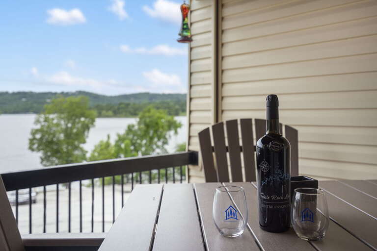 Lake View From Vacation Rental Balcony With Wine Bottle And Glasses