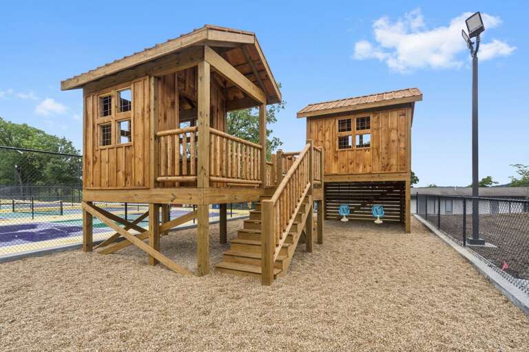 Wooden Playground Structures With Stairs On Mulch Ground