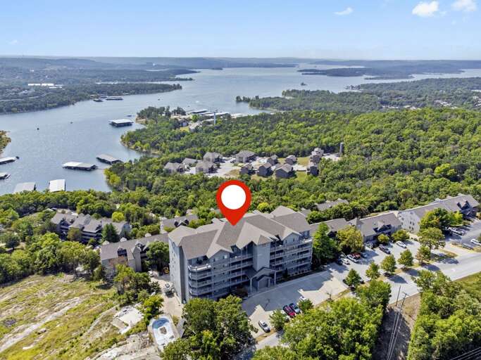 Aerial View Of Lakeside Residential Building With Red Marker