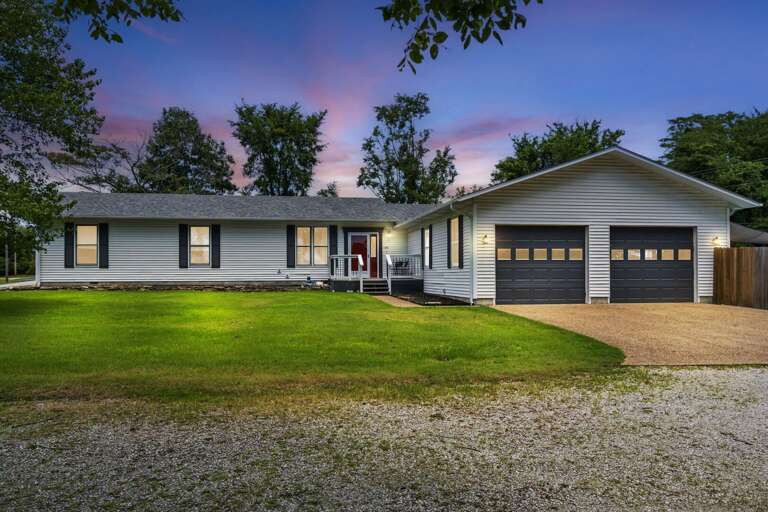 Suburban Single-story House With Garage At Dusk