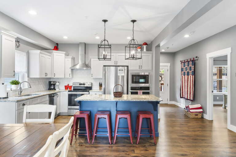 Spacious Kitchen Interior With Island And Pendant Lights