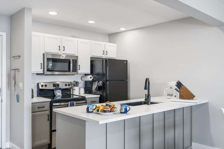 Kitchen Interior With White Cabinets And Black Appliances Kitchen Interior With White Cabinets And Black Appliances